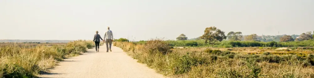 Elderly couple in love walking on a dust road, Portugal